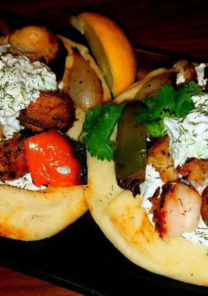 A picture of Mike's Chicken Kabobs With Tatziki Sauce & Naan Bread.