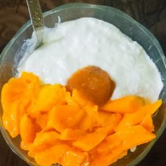 A picture of Chire Aam Doi (Dahi Poha with Mangoes).