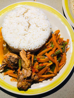 A picture of Chicken veggies sauce and rice.
