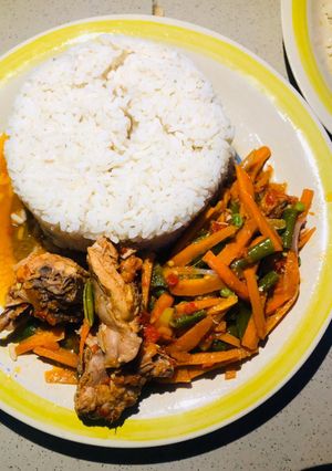 A picture of Chicken veggies sauce and rice.