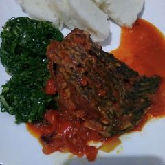 A picture of Wet fry fish with sukuma and ugali.
