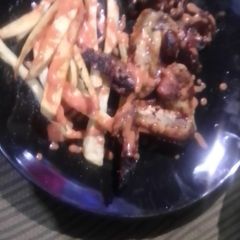 A picture of Chickens wings and fried chips.