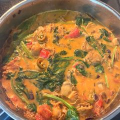 A picture of Coconut Curry with Hokkaido Scallops and Spinach.