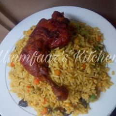 A picture of Fried rice and chicken.