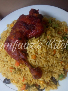 A picture of Fried rice and chicken.