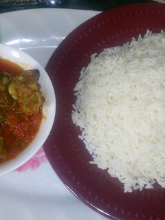 A picture of White rice and goatmeat stew.