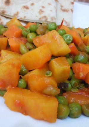 A picture of Sweet Potato Curry and peas served with naan bread.