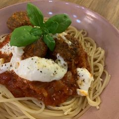 A picture of Meatballs in a rich tomato sauce with mozzarella.