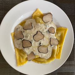 A picture of Ravioli with truffles and creamy tuna sauce.
