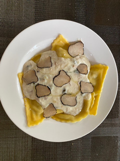 A picture of Ravioli with truffles and creamy tuna sauce.