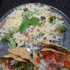 A picture of Broccoli sweet corn rice and masala papad.