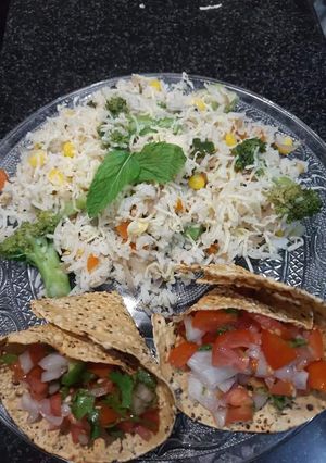 A picture of Broccoli sweet corn rice and masala papad.