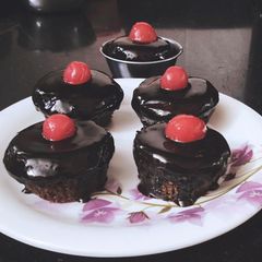 A picture of Chocolate cup cakes with chocolate ganache.