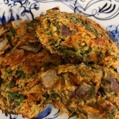 A picture of Baked carrot fritters with carrot tops - vegan.