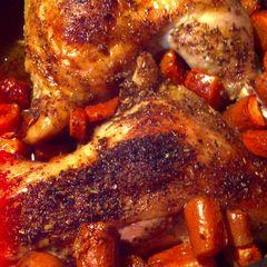 A picture of Roasted leg quarters with rotisserie rub and carrots.