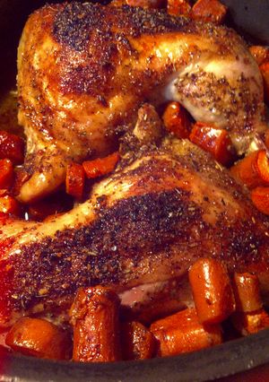 A picture of Roasted leg quarters with rotisserie rub and carrots.