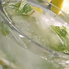 A picture of Nimbu Pani with mint leaves.