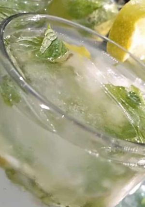 A picture of Nimbu Pani with mint leaves.
