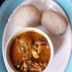 A picture of Goat meat native soup with fufu.