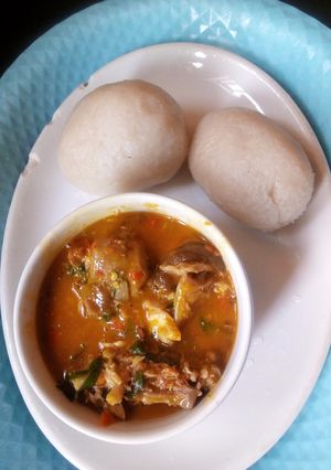 A picture of Goat meat native soup with fufu.
