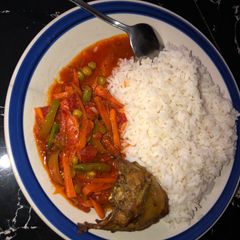 A picture of White rice and vegetable sauce.