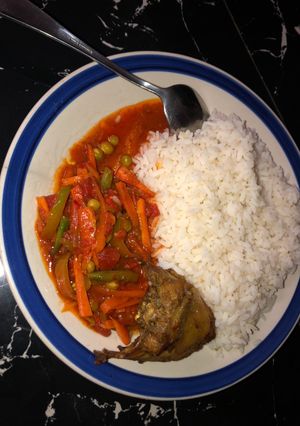 A picture of White rice and vegetable sauce.