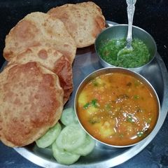 A picture of Moong Daal puri & Raseele Aloo.