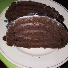 A picture of Chocolate roll cake with chocolate buttercream frosting.