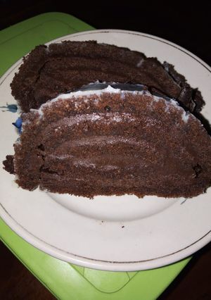 A picture of Chocolate roll cake with chocolate buttercream frosting.