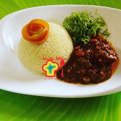 A picture of Couscous with tomato sauce.