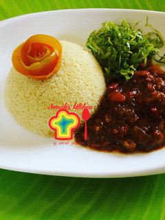 A picture of Couscous with tomato sauce.