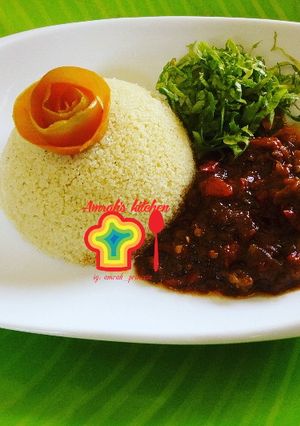 A picture of Couscous with tomato sauce.