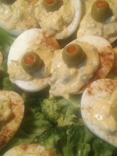 A picture of Deviled eggs and broccoli.
