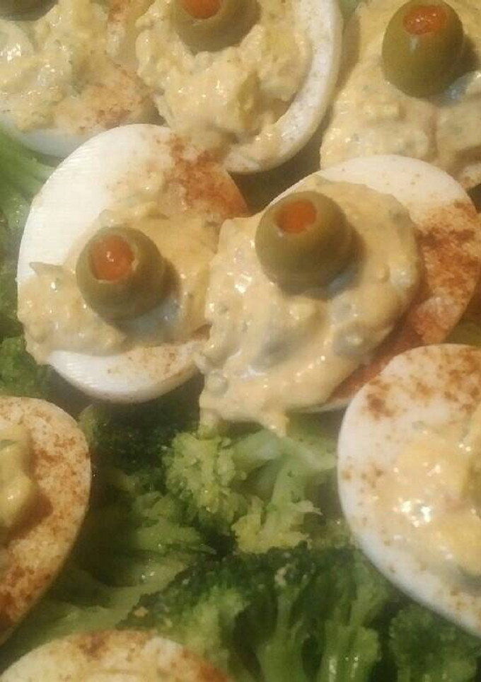 A picture of Deviled eggs and broccoli.