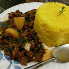 Tumeric rice served with beef stew A picture of Tumeric rice served with beef stew.