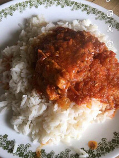 A picture of White rice with tomato stew.