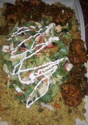A picture of Fried rice wt peppered tofu n salad.