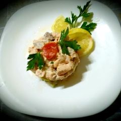 A picture of Salmon tartare with diet cheeses, lemon, olive oil.