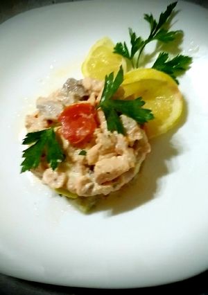 A picture of Salmon tartare with diet cheeses, lemon, olive oil.