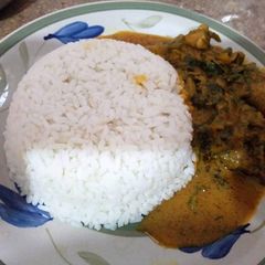 A picture of White rice with ofe akwu.