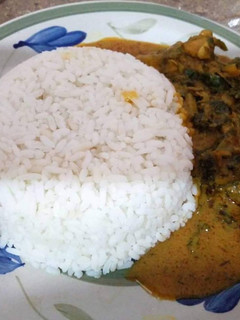 A picture of White rice with ofe akwu.