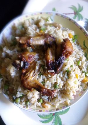 A picture of Coconut rice with chicken and veggies.