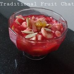 A picture of Traditional fruit chat with laal chutney dipping.