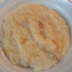 A picture of Cheesy Grits with Canadian Bacon.