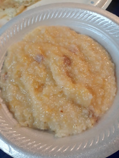 A picture of Cheesy Grits with Canadian Bacon.