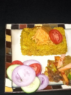 A picture of Fried rice with vegetable source and cucumber juice.