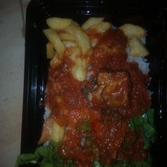 A picture of Rice & stew, with fried irish.