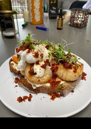 A picture of Scallops, nduja & poached duck eggs on sourdough with a mustard creme fraiche.