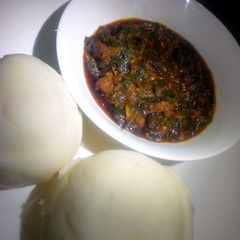A picture of Pounded yam and vegetable soup.
