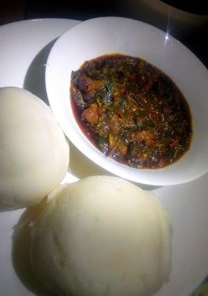 A picture of Pounded yam and vegetable soup.